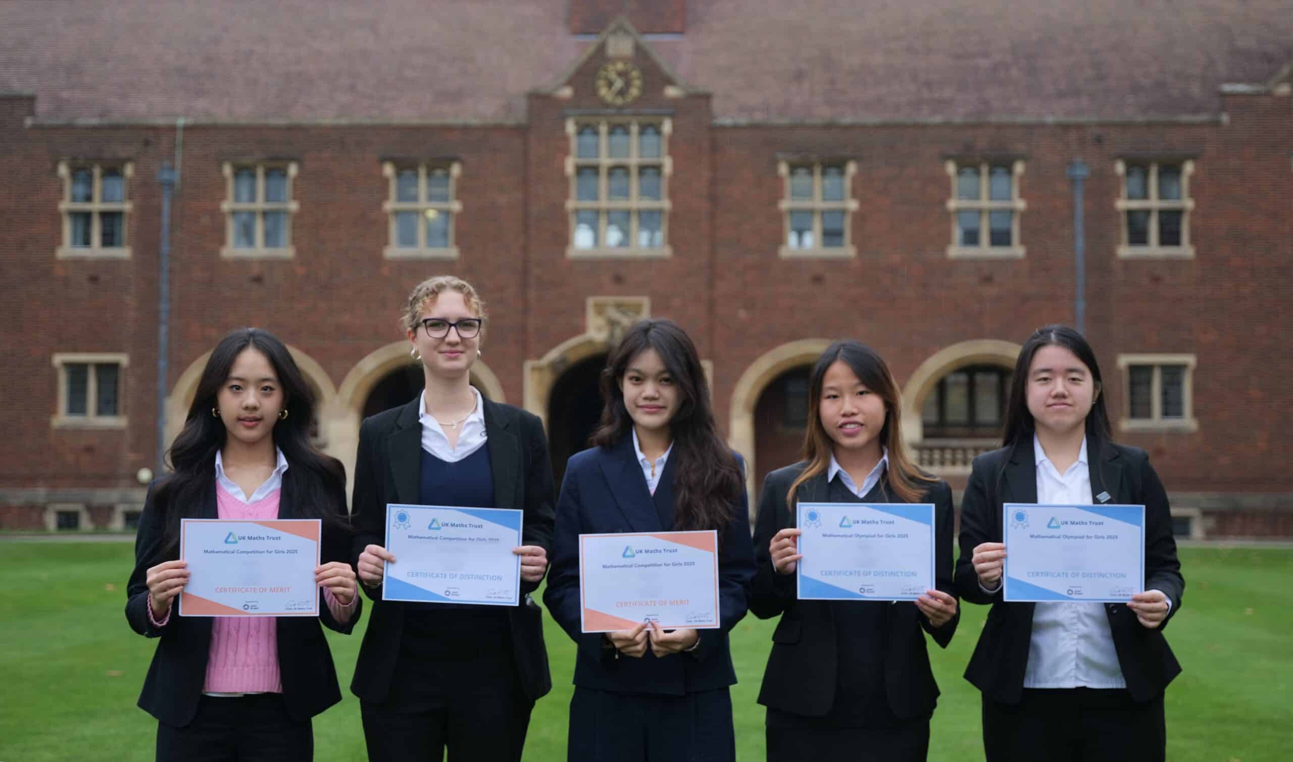 5 pupils stand side by side holding their certificates.